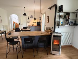 a kitchen with a wooden table and a stove at Alla Stella B&B in Vo Euganeo
