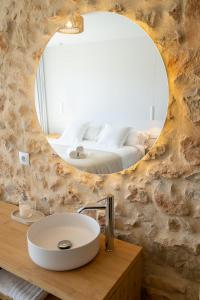 a bathroom with a sink and a large mirror at OSTALEA Casa Rural in Villanueva de Alcolea +16 photos