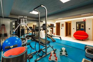 a fitness room with a gym with a simulator at Coudour Boutique Hotel in Pesádha +59 photos