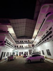a parking lot with cars parked in a building at Elowen Suites in Manjeri