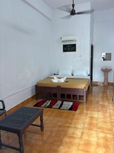 a room with a bed and a table in it at Elowen Suites in Manjeri +40 photos