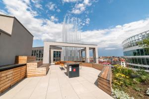 a rooftop patio with a view of a building at MamaStay Andel Apartments in Prague