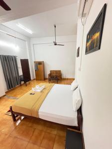a bedroom with a large bed in a room at Elowen Suites in Manjeri