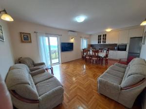a living room with a couch and chairs and a table at House Leana Herceg Novi in Herceg-Novi