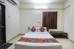 a bedroom with a large bed in a room at FabHotel Krishna Inn in Hinjewadi +19 photos