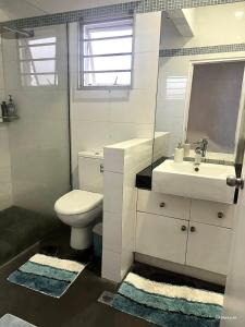 a white bathroom with a sink and a toilet at 3BR Oceanview Villas - Raisara Retreat, Central Suva in Suva +5 photos