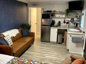 a living room with a couch and a kitchen at Cozy Tiny Home Cabin in Eva, TN in Eva +18 photos