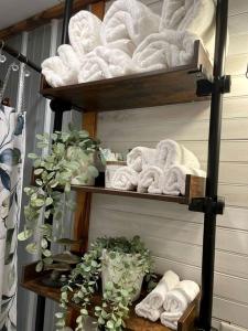 a towel rack with towels and towels at Cozy Tiny Home Cabin in Eva, TN in Eva