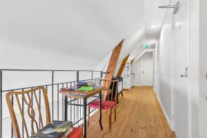 a room with a table and chairs on a balcony at Vånga 771 in Örkelsö