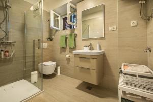 a bathroom with a toilet and a sink and a shower at Rooms Feme in Trogir +8 photos
