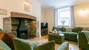 a living room with a couch and a fireplace at Number eight in Beaumaris