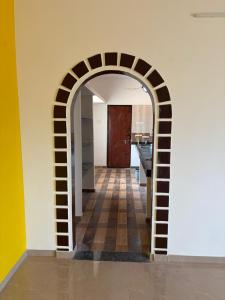 a hallway with an archway in a kitchen at Solace in Coimbatore