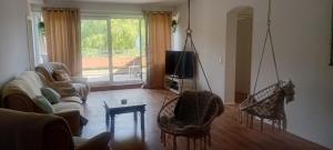 a living room with two chairs and a swing at Saarlouis2 in Saarlouis