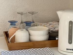 a wooden tray with dishes and glass vases at Rooms Feme in Trogir