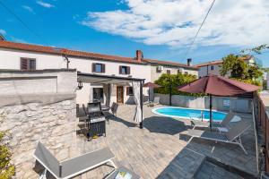 a villa with a swimming pool and a house at Villa Franka with heated pool in Milohnići