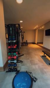 a room with a bunch of dumbbells in a gym at VISTA AZUL Prime in Domingos Martins
