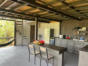 a kitchen with a table and chairs in a kitchen at Peaceful Waterfall Homestay - Nhà Bên Thác in Hoat +28 photos