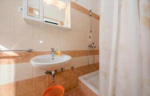 a bathroom with a sink and a shower at App&Rooms Anica Kampor in Kampor +82 photos