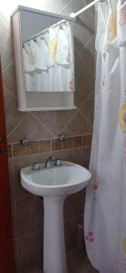 a bathroom with a sink and a mirror at Del Centro Dptos in Federación +18 photos