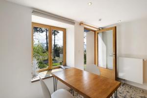 a dining room with a wooden table and chairs at Sorbier Des Oiseaux in Font-Romeu