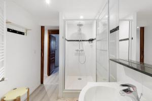 a white bathroom with a shower and a sink at Lis Martagon in Font-Romeu +16 photos