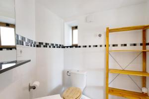 a bathroom with a toilet and a wooden shelf at Sorbier Des Oiseaux in Font-Romeu +19 photos