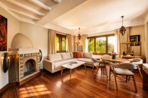 a living room with a couch and a fireplace at Hivernage Marrakech in Marrakesh
