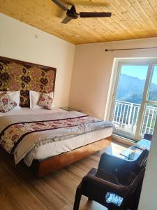 a bedroom with a bed and a large window at Saadhan Homestay in Mussoorie