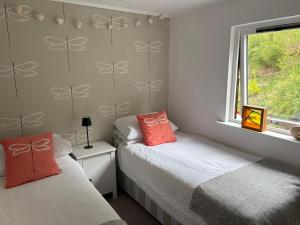 a bedroom with two beds and a window at Stags View in Invergarry