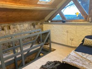 a room with a bed and a window at The Stable Sleeps 2 with Parking in Llanfairpwllgwyngyll