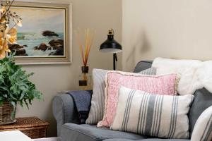 a living room with a chair and a painting at The Barn in South Cerney