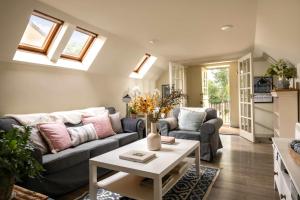 a living room with a couch and a table at The Barn in South Cerney