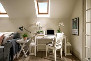 a bedroom with a desk with a laptop computer on it at The Barn in South Cerney