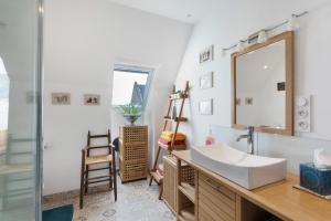 a bathroom with a sink and a mirror at Macleo proche plage in Plougasnou +33 photos