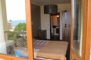 a room with a view of a balcony with a bed at Golden Sands Rentals Apartments in Golden Sands