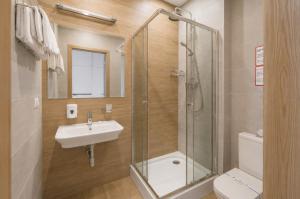 a bathroom with a shower and a sink and a toilet at Poet Art Hotel in Odesa