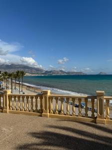 a fence on a beach with the ocean at Almar Albir in Albir