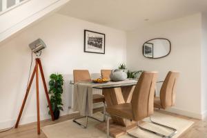 a dining room with a table and chairs at Aintree Cottage in Cirencester