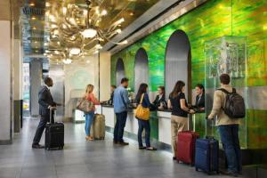 a group of people standing in a lobby with luggage at OYO Times Square in New York +78 photos
