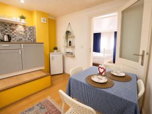 a dining room with a table and a kitchen at Bella de rezidans in Istanbul +28 photos