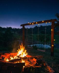 a fire pit in a yard at night with lights at Encanto Glamping in Las Dalias