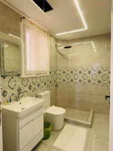 a bathroom with a toilet and a sink at Le caire Hotel & suits in Cairo +27 photos