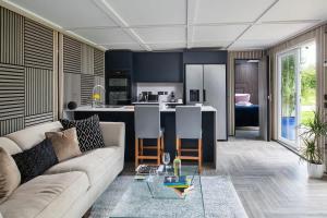 a living room with a couch and a kitchen at Badgers Sett in Hankerton
