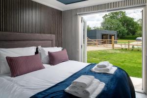 a bedroom with a bed with towels on it at Badgers Sett in Hankerton