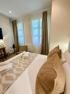 a large white bed with a pillow on top of it at VTZ The Orus Factory Hotel - Parking Muy Económico in Zaragoza