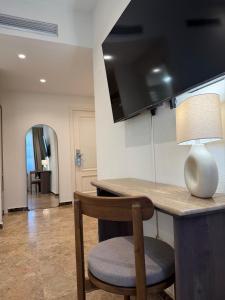 a room with a table with a lamp and a chair at VTZ The Orus Factory Hotel - Parking Muy Económico in Zaragoza +62 photos
