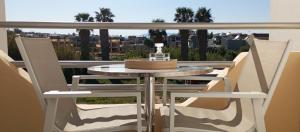a table and chairs on a balcony with a view at Sunshine Apartments in Kato Daratso