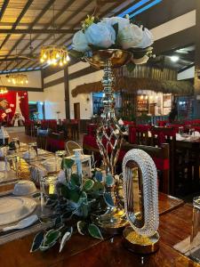 a table with a centerpiece with flowers on top of it at Terra Verde Resort Guindulman Bohol in Guindulman