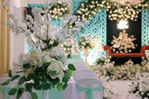 a room with a table with white flowers on it at Terra Verde Resort Guindulman Bohol in Guindulman