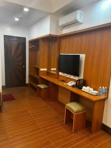 a room with a desk with a television on it at Terra Verde Resort Guindulman Bohol in Guindulman